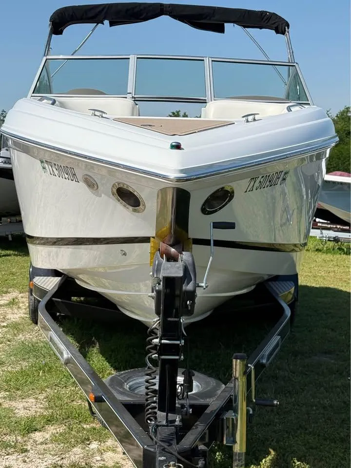 Slide: The Image of 2012 Cobalt 242 boat on trailer, parked on grass, front view. - 3