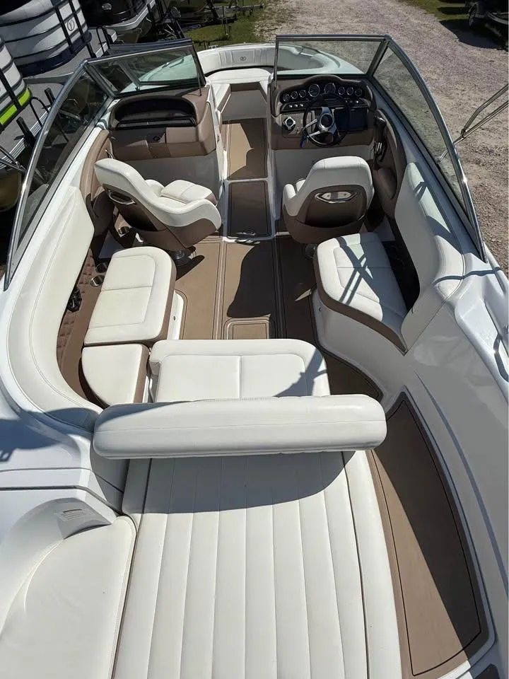 Slide: The Image of 2012 Cobalt 242 boat interior with white leather seating and modern dashboard. - 5