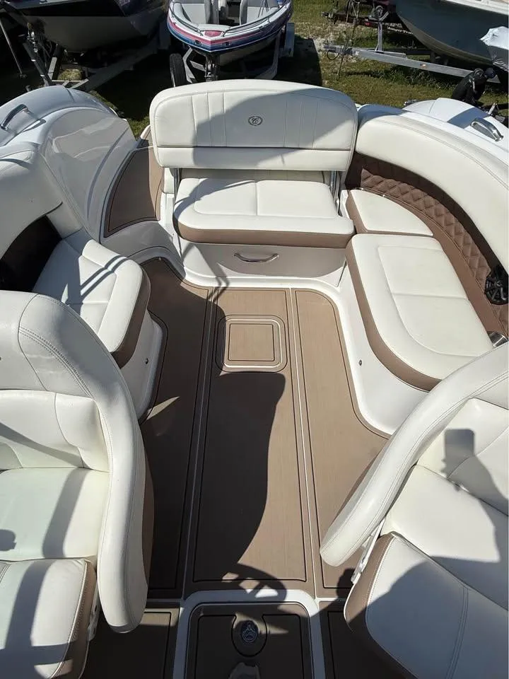 Slide: The Image of 2012 Cobalt 242 boat interior with white leather seating and tan flooring. - 6