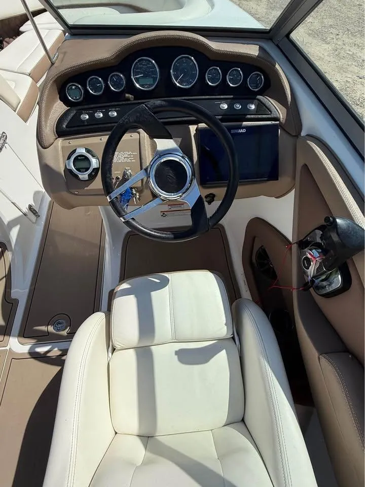Slide: The Image of 2012 Cobalt 242 boat interior with steering wheel and dashboard controls. - 7