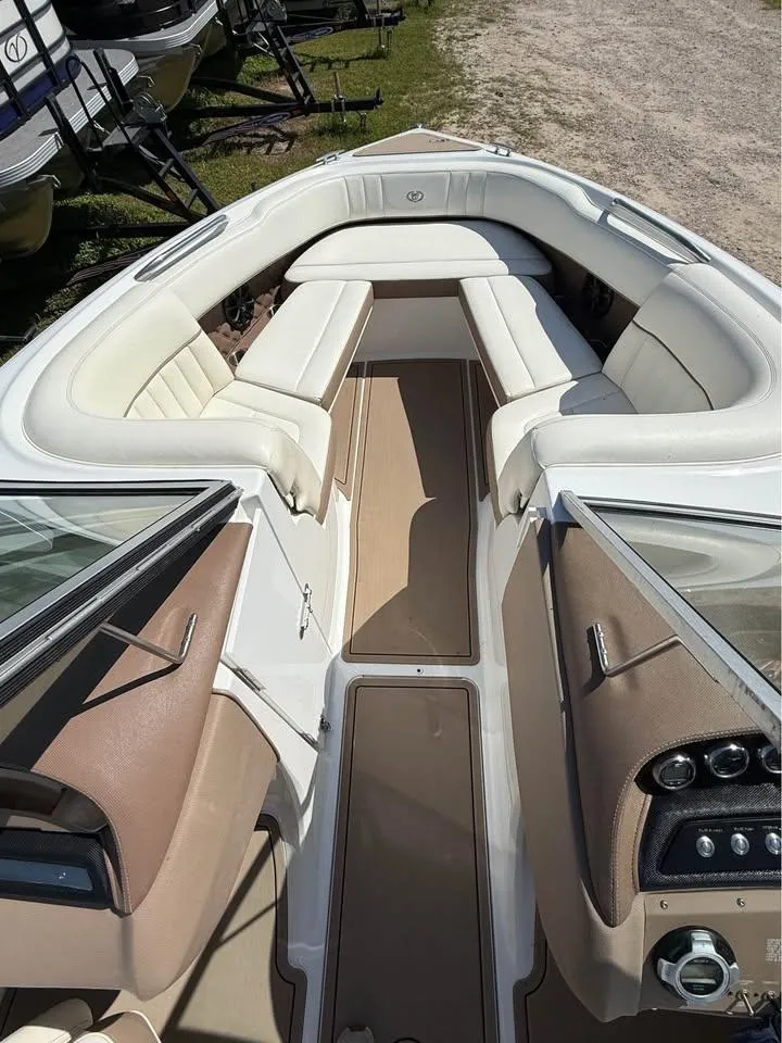 Slide: The Image of 2012 Cobalt 242 boat interior with white seating and beige accents. - 9