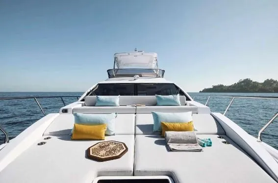 Slide: The Image of 2024 Azimut 50 Fly yacht with luxurious sunbathing area, cushions, and ocean view. - 4