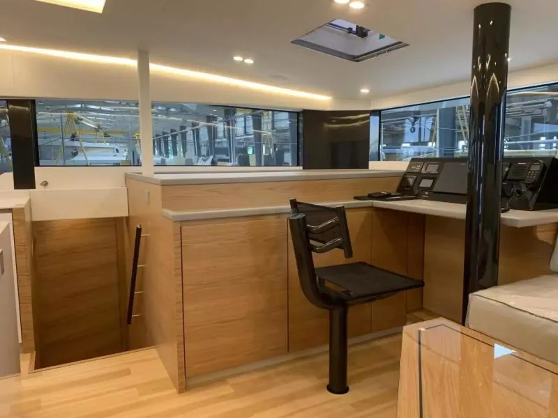 Slide: The Image of Modern interior of 2026 McConaghy MC55 yacht with sleek wood finishes and navigation station. - 11