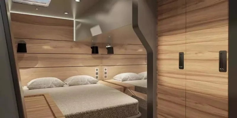 Slide: The Image of Luxurious interior of 2026 McConaghy MC55 yacht with modern wood paneling and cozy bedding. - 20