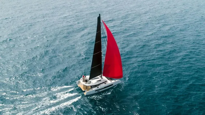 Slide: The Image of Sailing yacht McConaghy MC55 2026 with black and red sails on open sea. - 7
