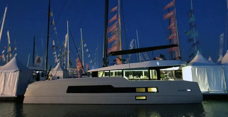 Slide: The Image of Luxury McConaghy MC55 yacht at night, docked with illuminated interior, 2026 model. - 8