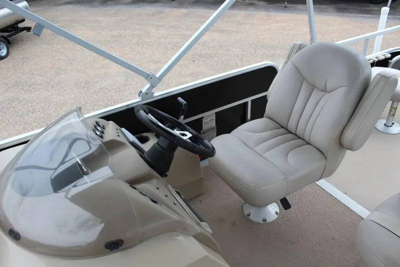 Slide: The Image of 2010 Bennington 2275 Fish boat interior with steering wheel and captain's chair. - 10