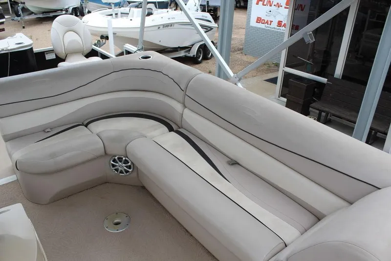 Slide: The Image of 2010 Bennington 2275 Fish boat interior with beige seating and speaker. - 11