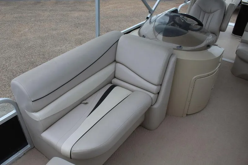 Slide: The Image of 2010 Bennington 2275 Fish boat interior with beige seating and helm. - 15
