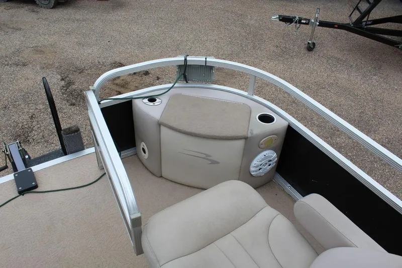 Slide: The Image of 2010 Bennington 2275 Fish pontoon boat interior with seating and cup holders. - 2