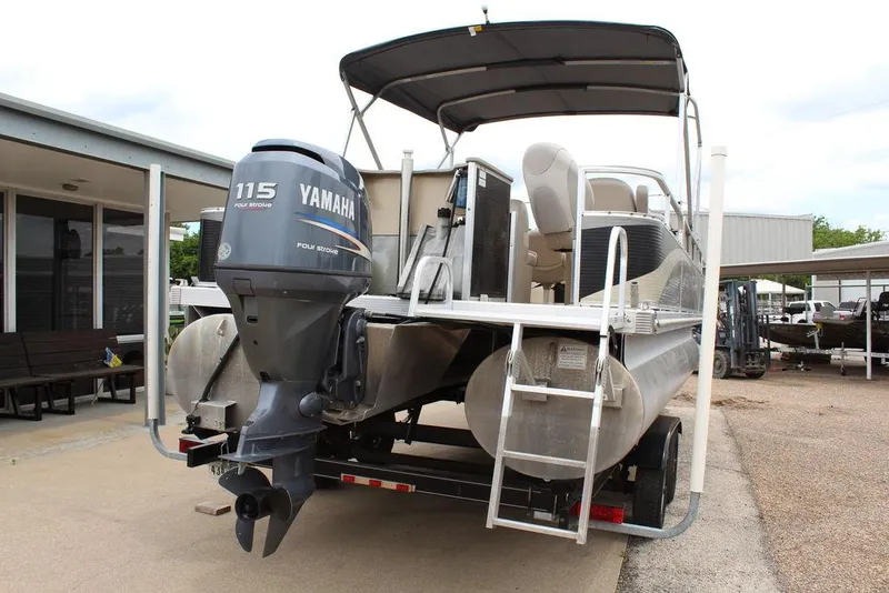 Slide: The Image of 2010 Bennington 2275 Fish pontoon boat with Yamaha 115 outboard motor, parked on trailer. - 20