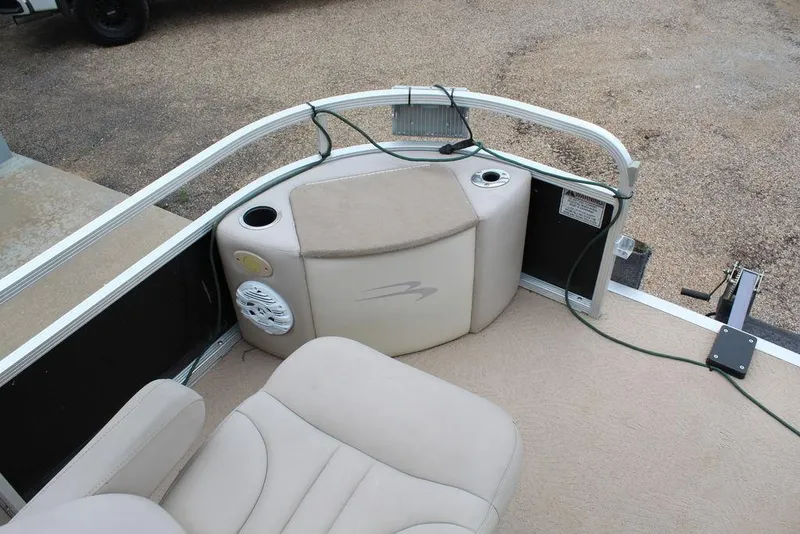 Slide: The Image of 2010 Bennington 2275 Fish boat interior with beige seating and cup holders. - 3