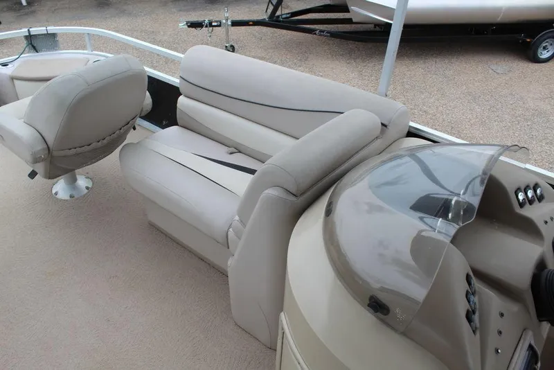 Slide: The Image of 2010 Bennington 2275 Fish boat interior with beige seating and helm. - 4