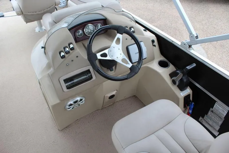 Slide: The Image of 2010 Bennington 2275 Fish boat dashboard with steering wheel and controls. - 6