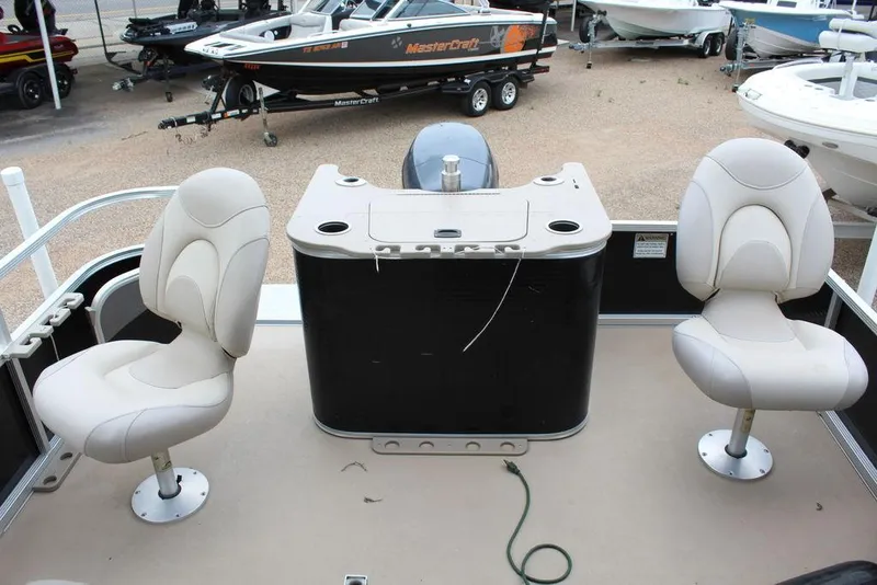 Slide: The Image of 2010 Bennington 2275 Fish pontoon boat interior with two swivel seats and a central console. - 8