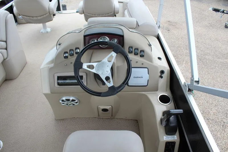 Slide: The Image of 2010 Bennington 2275 Fish boat dashboard with steering wheel and controls. - 9