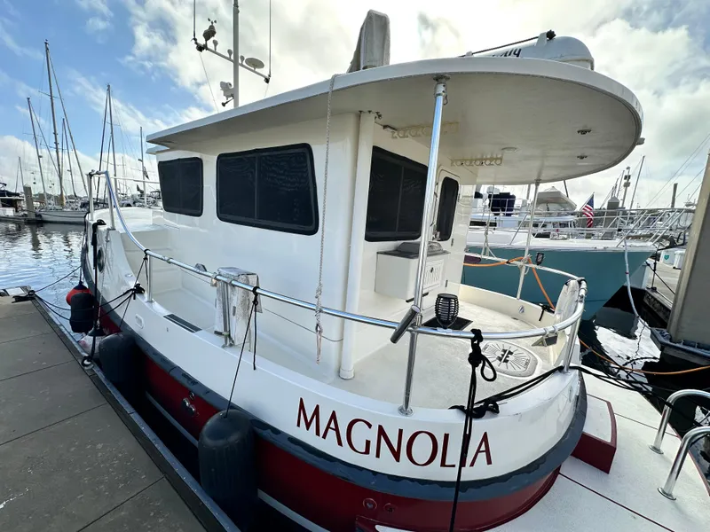 Slide: The Image of 2005 Great Harbour N37 boat "Magnolia" docked at a marina with other vessels. - 10