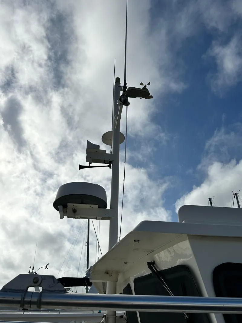 Slide: The Image of Great Harbour N37 boat mast against cloudy sky, 2005 model. - 14