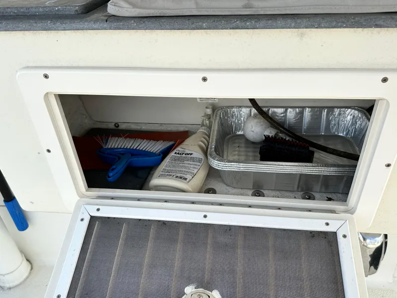 Slide: The Image of Storage compartment on a 2005 Great Harbour N37 boat with cleaning supplies and tools. - 16