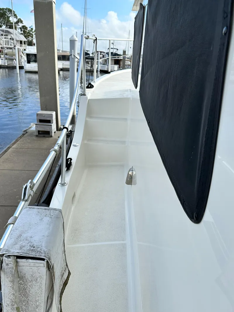 Slide: The Image of 2005 Great Harbour N37 yacht deck with railing and dockside view. - 19