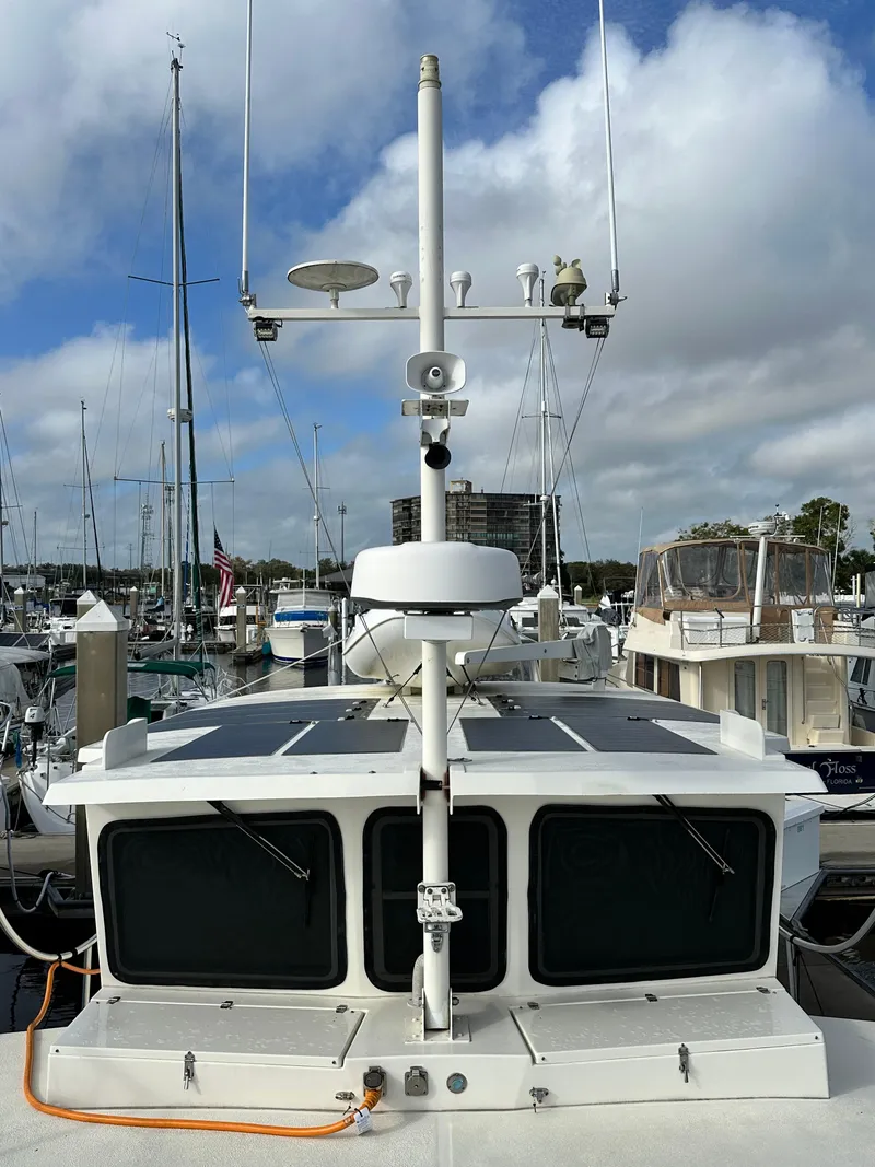 Slide: The Image of 2005 Great Harbour N37 yacht docked at marina under cloudy sky. - 23