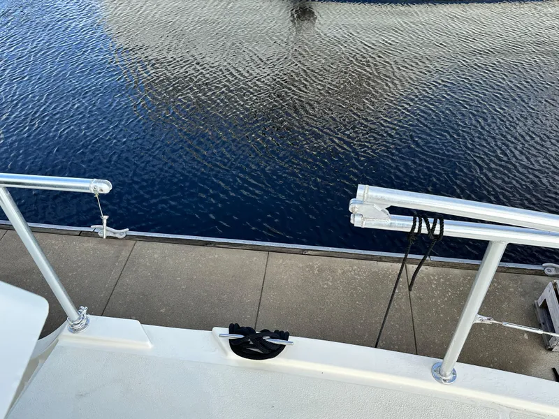 Slide: The Image of Great Harbour N37 boat docked, showing railing and water reflection, 2005 model. - 33