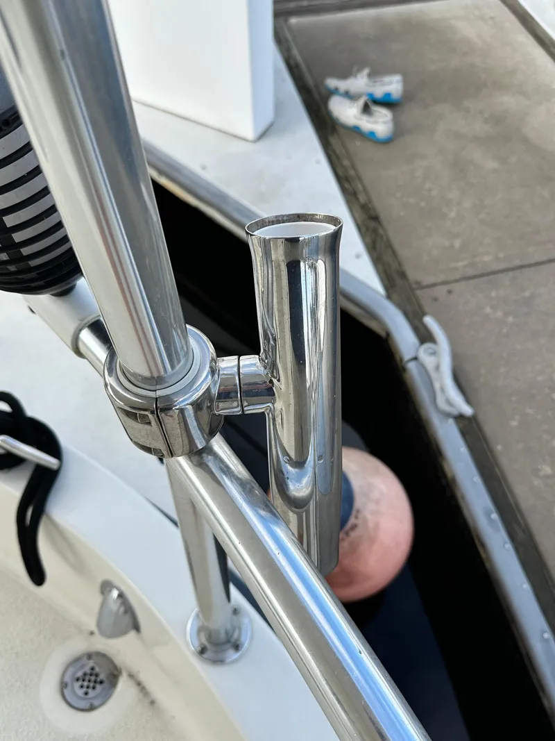 Slide: The Image of Chrome railing on 2005 Great Harbour N37 boat, dockside with shoes visible. - 34