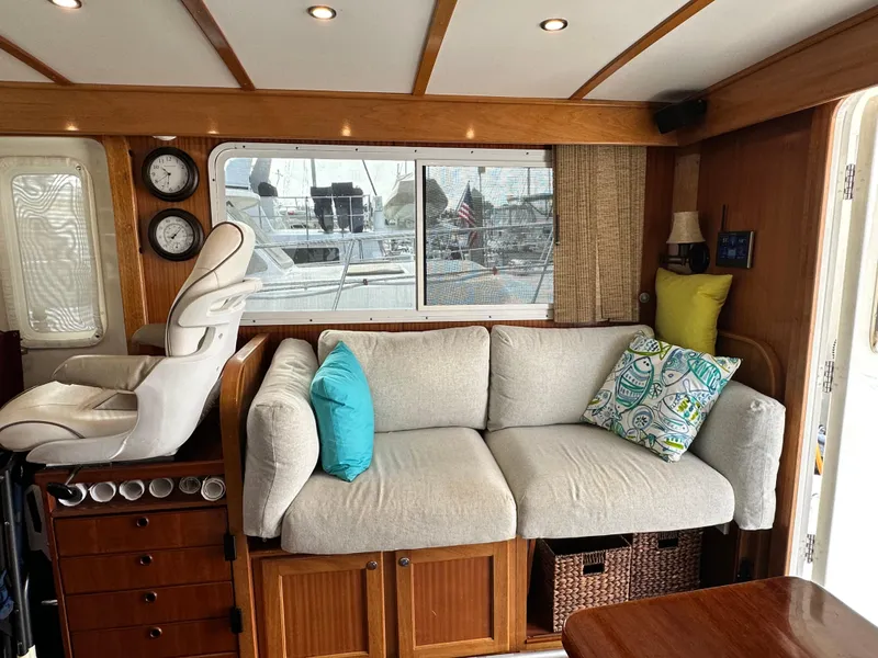 Slide: The Image of Cozy interior of 2005 Great Harbour N37 yacht with sofa, cushions, and helm chair. - 39