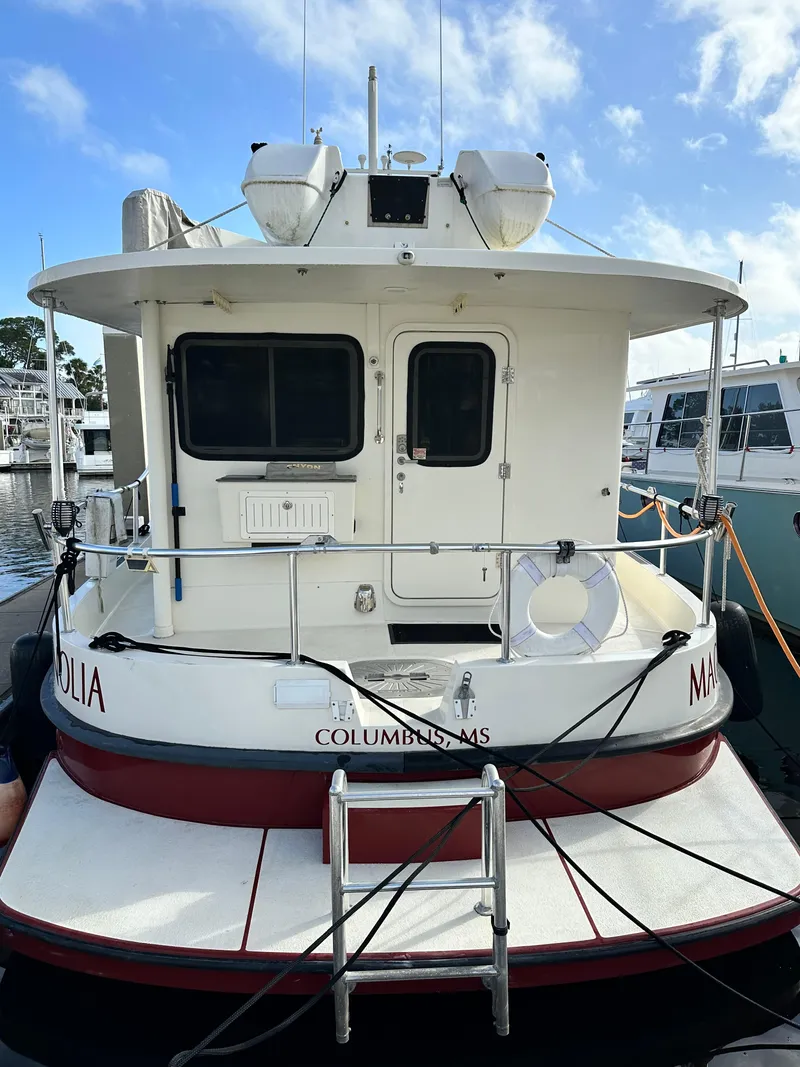 Slide: The Image of 2005 Great Harbour N37 boat docked at marina, rear view with ladder and lifebuoy. - 4