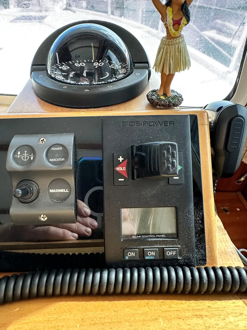 Slide: The Image of Control panel of a 2005 Great Harbour N37 boat with compass and hula dancer figurine. - 45