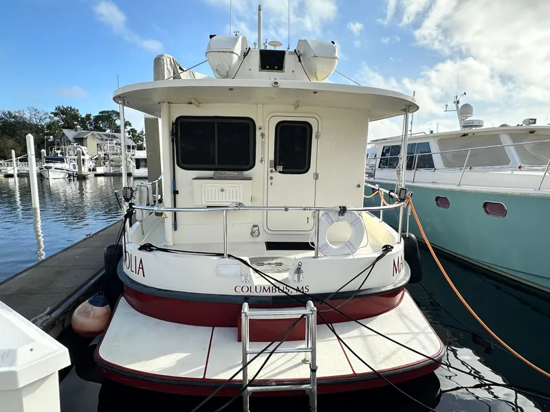 Slide: The Image of 2005 Great Harbour N37 boat docked at marina, rear view with clear sky. - 5