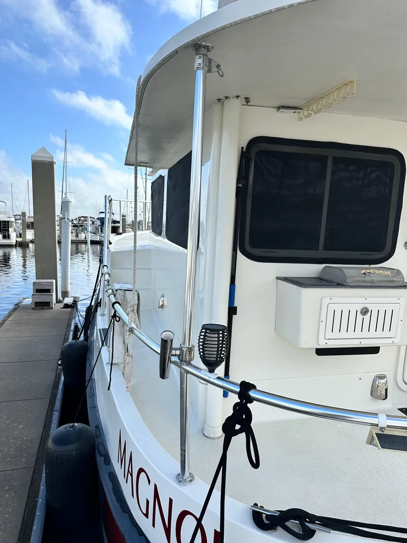 Slide: The Image of 2005 Great Harbour N37 boat docked at marina under blue sky. - 8