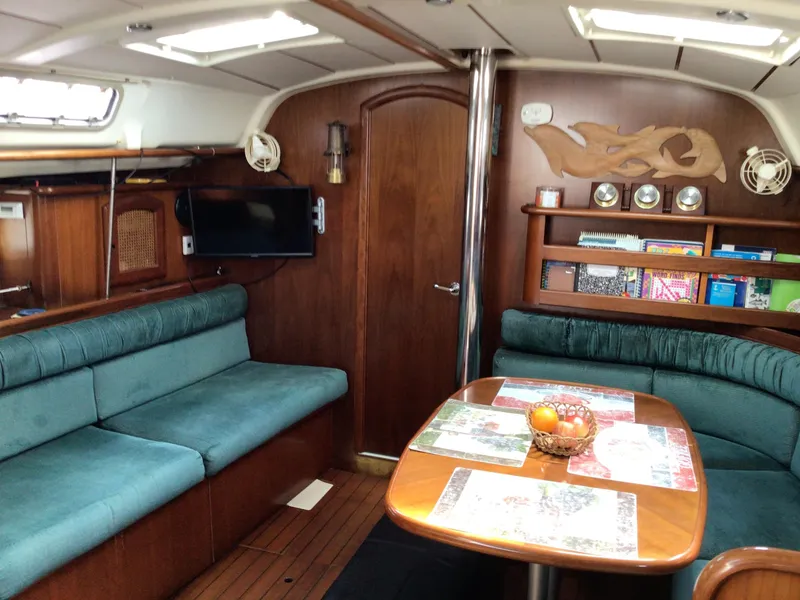 Slide: The Image of Interior of 2000 Beneteau Oceanis 40 yacht with cozy seating and wooden decor. - 10