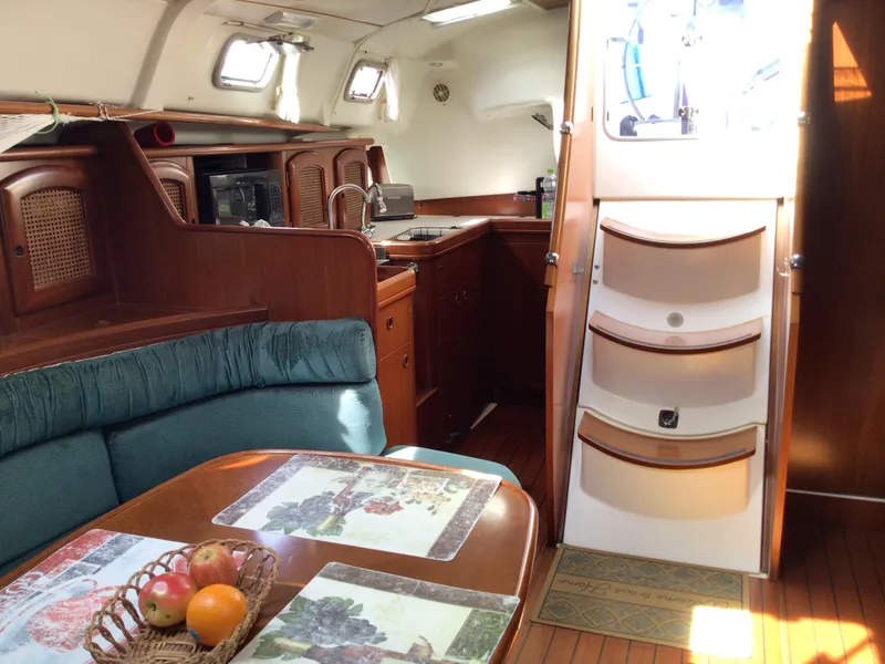 Slide: The Image of Interior of 2000 Beneteau Oceanis 40 sailboat with dining area and kitchen. - 12