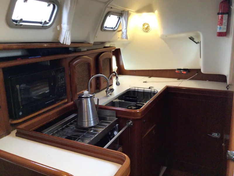 Slide: The Image of Beneteau Oceanis 40 yacht kitchen interior with stove, sink, and microwave, year 2000 model. - 14