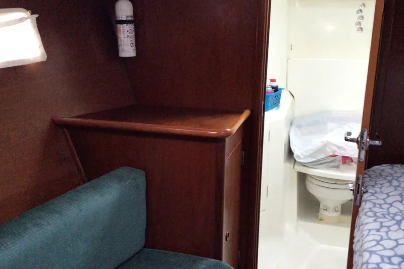 Slide: The Image of Interior of 2000 Beneteau Oceanis 40 yacht showing bathroom and seating area. - 18