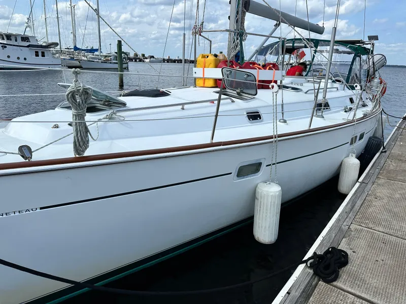 Slide: The Image of Beneteau Oceanis 40 sailboat docked at marina, 2000 model, with clear skies. - 2