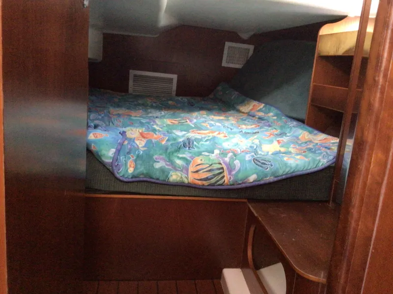 Slide: The Image of Cozy cabin interior of 2000 Beneteau Oceanis 40 sailboat with colorful bedding. - 21