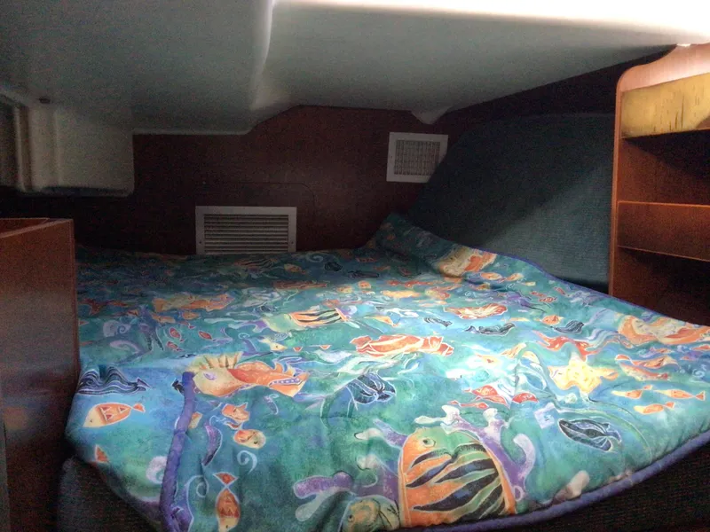 Slide: The Image of Cozy cabin interior of 2000 Beneteau Oceanis 40 with colorful fish-themed bedding. - 22