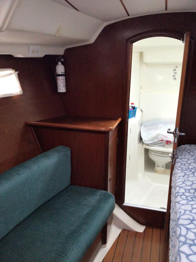 Slide: The Image of Interior of 2000 Beneteau Oceanis 40 yacht, featuring a cozy cabin and compact bathroom. - 26