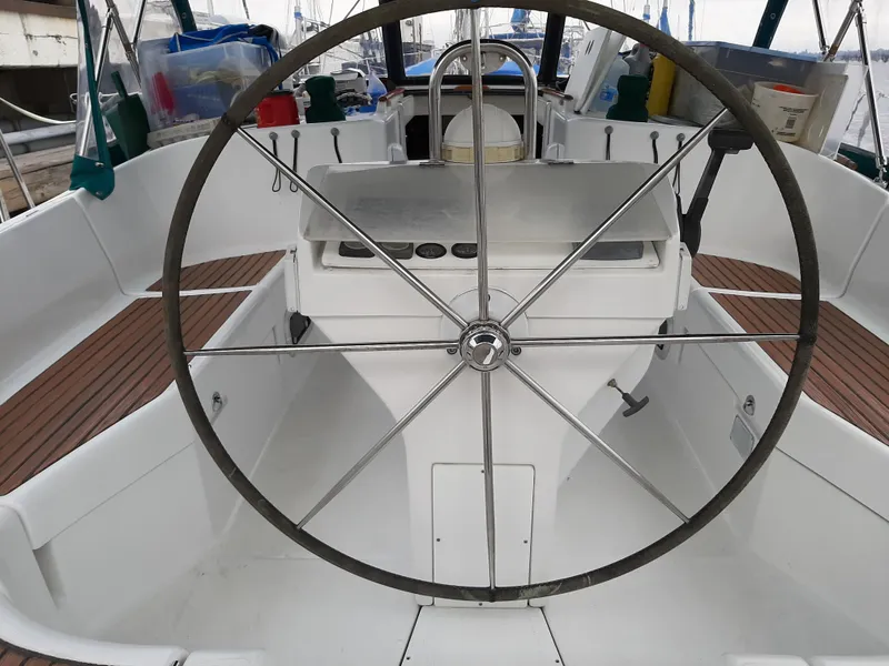 Slide: The Image of Cockpit of a 2000 Beneteau Oceanis 40 sailboat with large steering wheel. - 6