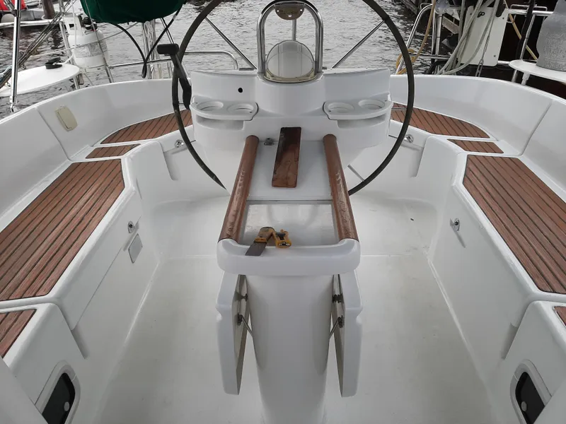 Slide: The Image of Cockpit of 2000 Beneteau Oceanis 40 sailboat with wooden accents and steering wheel. - 7