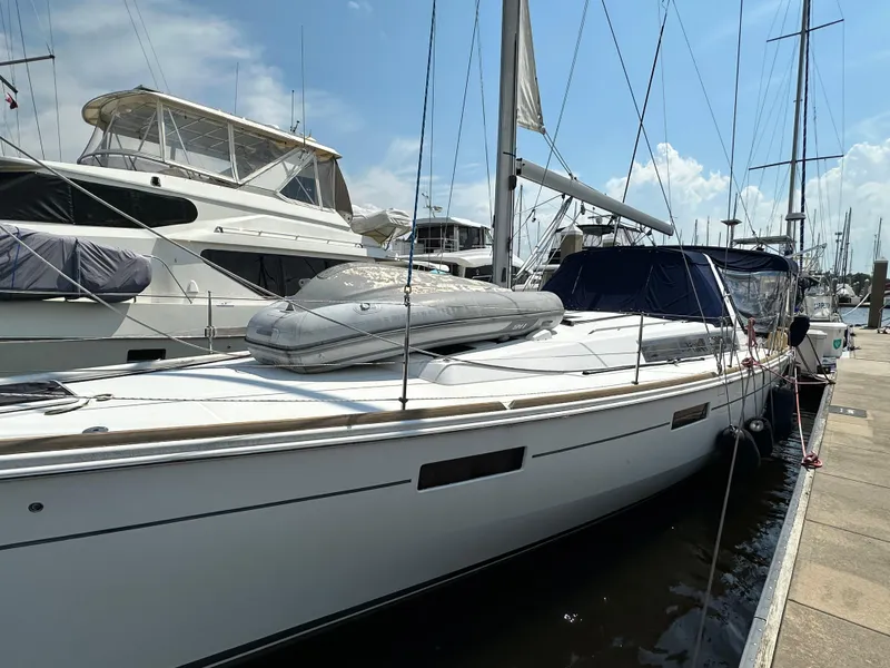 Slide: The Image of 2014 Beneteau Oceanis 45 sailboat docked at marina under clear sky. - 10