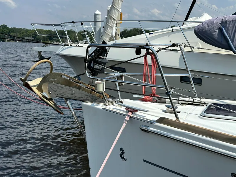 Slide: The Image of 2014 Beneteau Oceanis 45 sailboat docked, featuring anchor and deck details. - 11