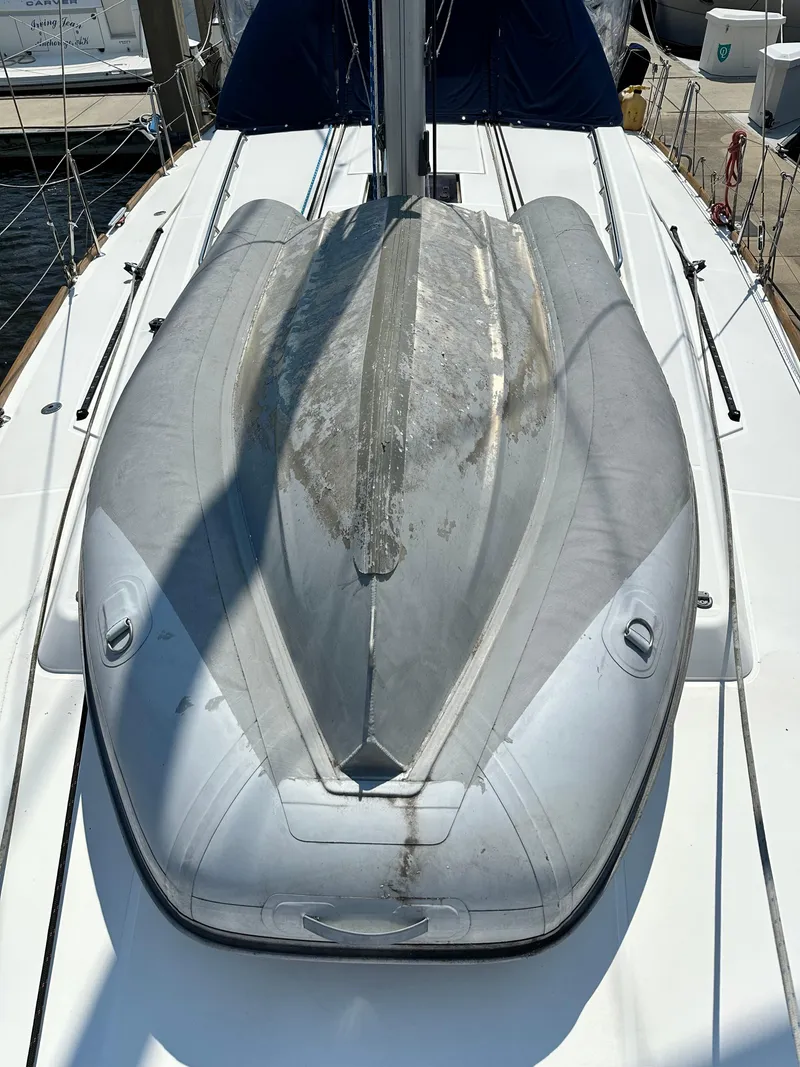 Slide: The Image of 2014 Beneteau Oceanis 45 sailboat deck with an inflatable dinghy secured on top. - 14