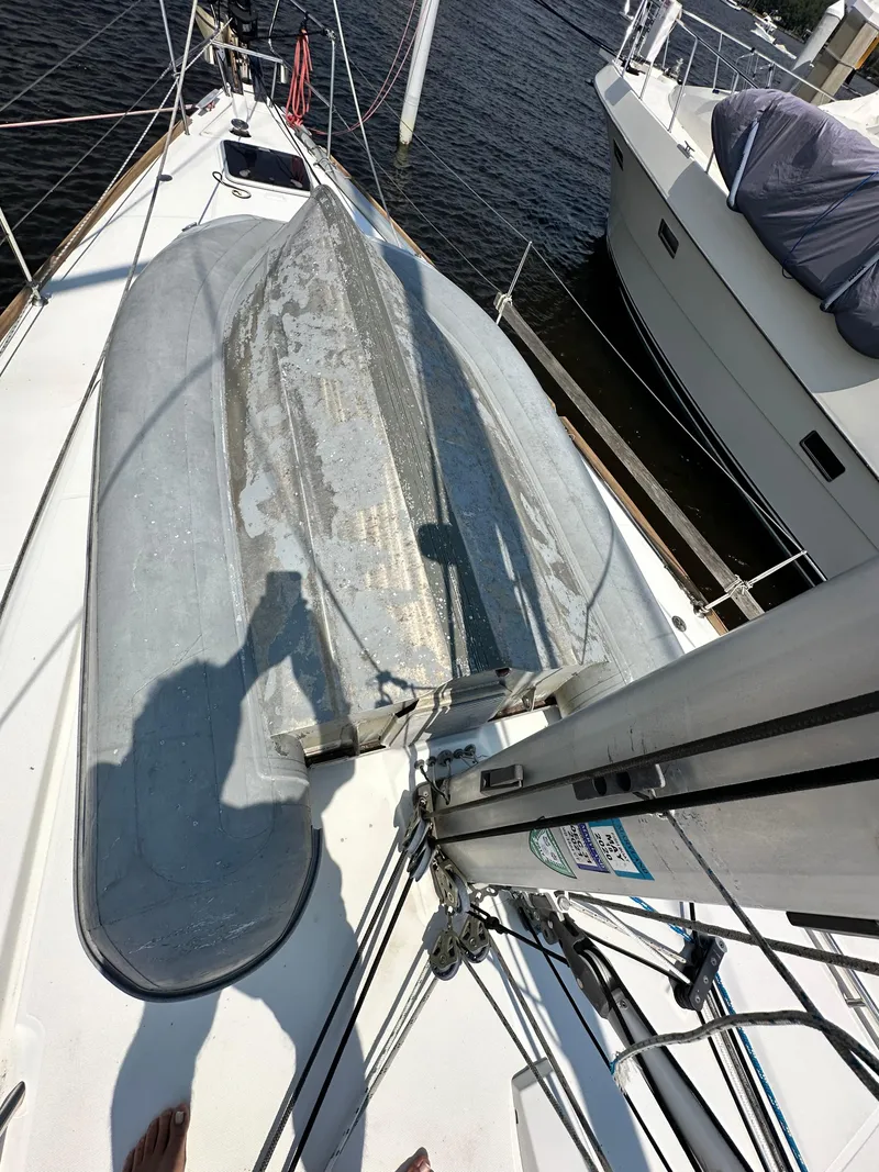 Slide: The Image of Beneteau Oceanis 45 sailboat deck with dinghy, 2014 model, docked at marina. - 18