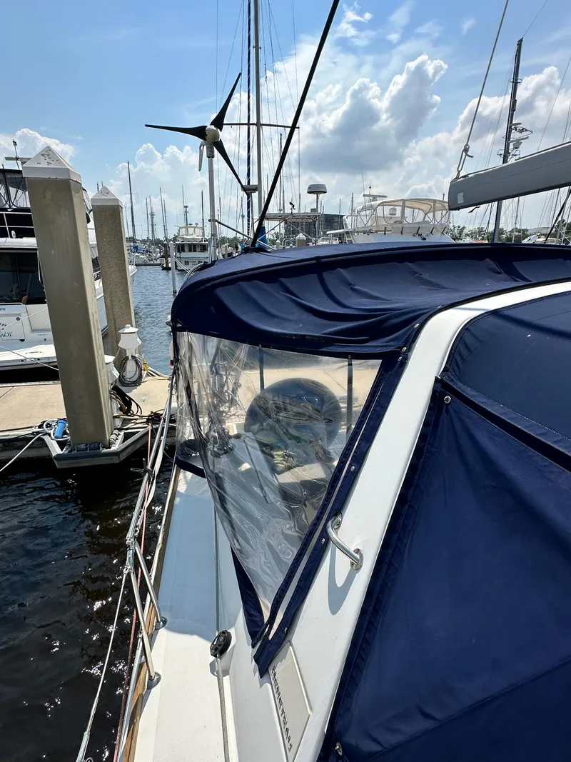 Slide: The Image of 2014 Beneteau Oceanis 45 sailboat docked at marina under blue sky. - 21