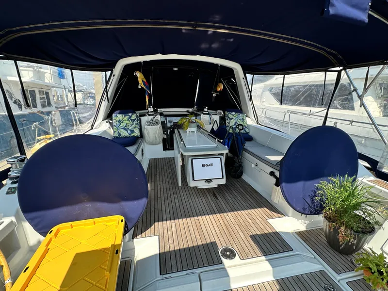 Slide: The Image of 2014 Beneteau Oceanis 45 yacht cockpit with seating, plants, and nautical decor. - 25