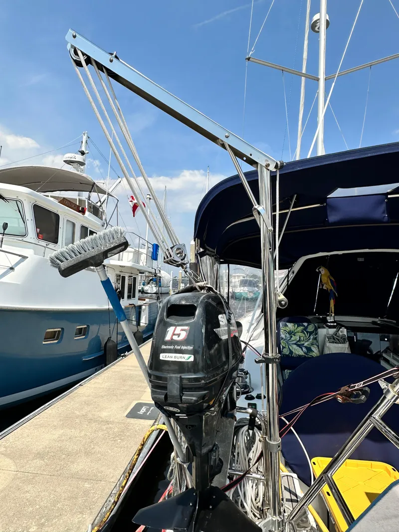 Slide: The Image of 2014 Beneteau Oceanis 45 sailboat docked, featuring a motor and cleaning equipment. - 27