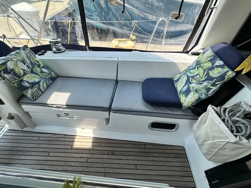 Slide: The Image of Cozy seating area on a 2014 Beneteau Oceanis 45 sailboat with leaf-patterned cushions. - 39